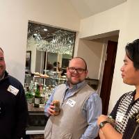 Four DC alumni talking together.